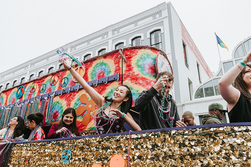 People Throwing Beads from Float