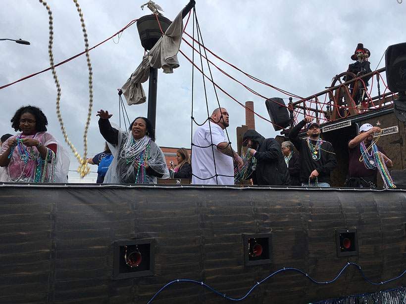 People Throwing Beads from Pirate Ship Float
